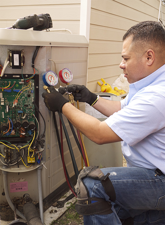 Cool Tech technician servicing an air conditioning unit in Dallas, TX